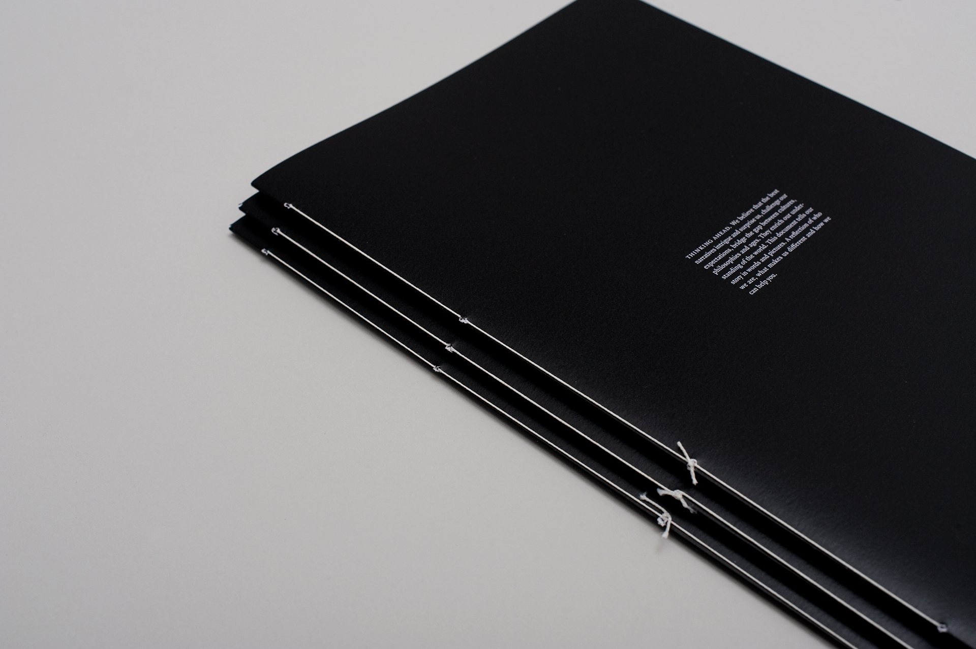 Thread bound cover design for a legal firm brochure.